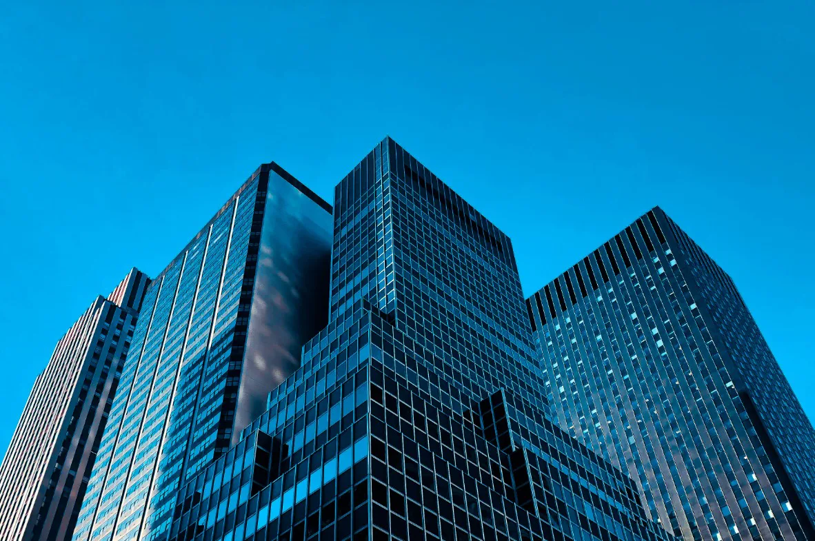 A skyline of tall buildings in Dubai against a clear blue sky